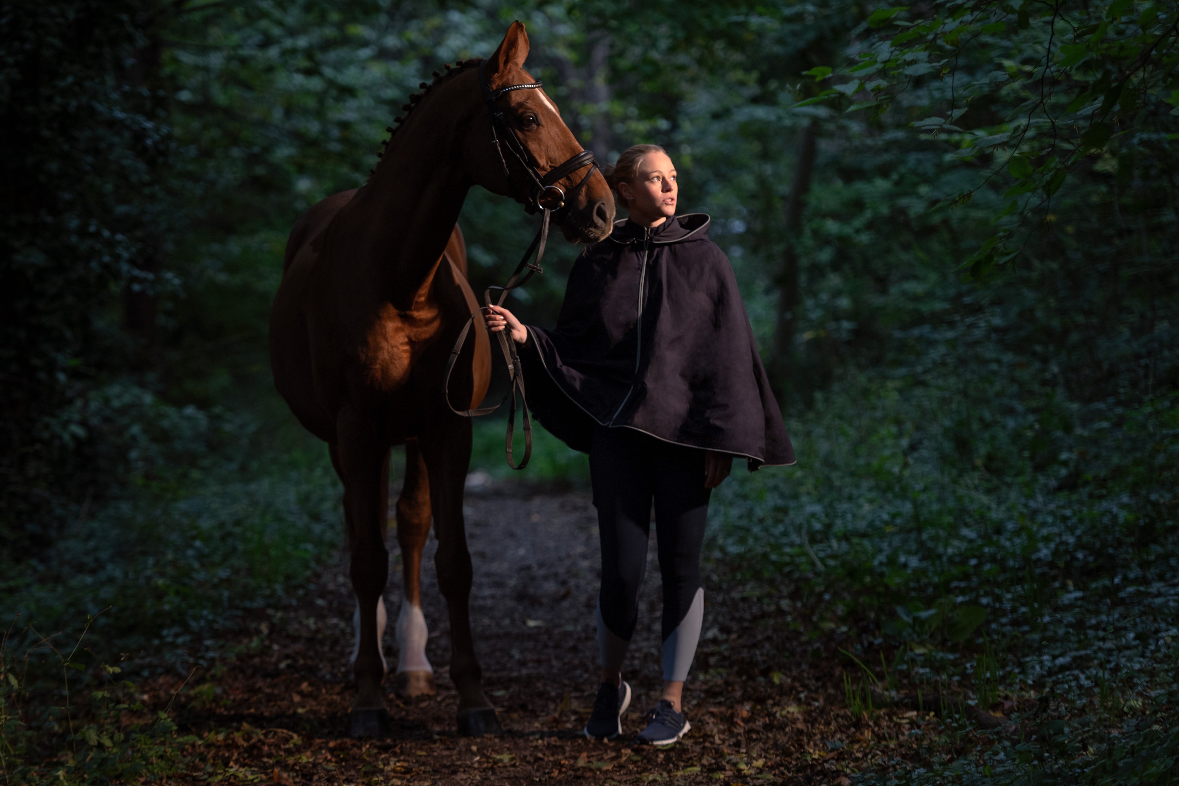 Founder Christine wears the Elisabeth Poncho and Anne leggings with her horse